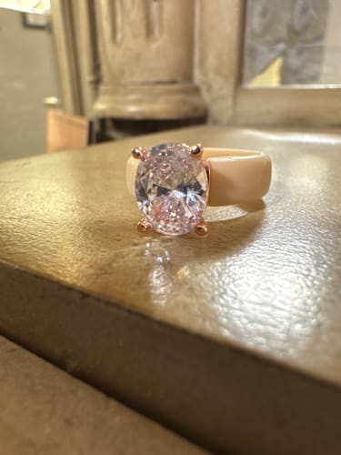 A customer's close-up photo of the Silicone Ring, showing the sparkling oval-cut CZ stone and the cream-colored band.