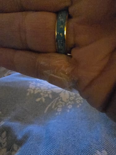 Close-up: Customer's hand wearing the Azara ring, showing the turquoise inlay and gold-colored band.