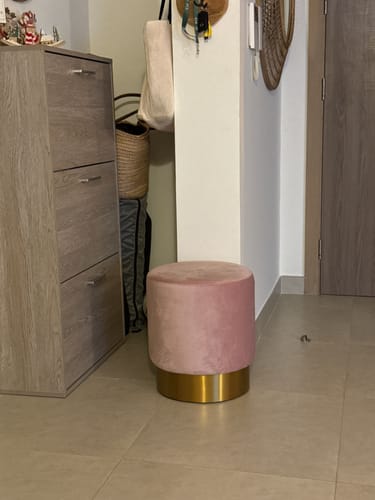 Customer's Velletri Stool in pastel pink and gold, shown in their home's entryway on a tiled floor.