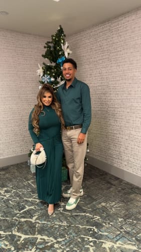 Customer wearing the green Naked Mock Neck Drape Tie Dress, shown in a full-length view indoors.