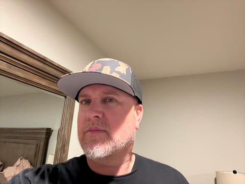 Customer wearing the Big Flat Bill Structured Watersport Hat with a camo pattern and gray bill.