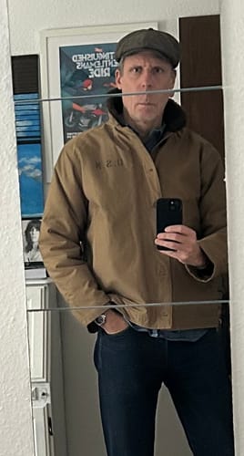 Reviewer in a mirror selfie showing the fit of their tan 1940s US Navy N-1 Deck Jacket.