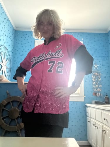 Reviewer wearing the pink sparkle-effect custom baseball jersey, posing with hands on hips.