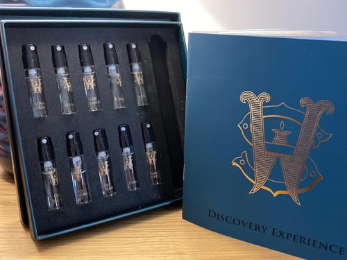 Customer's Discovery Set, showing multiple fragrance samples in the open box next to the teal outer packaging.
