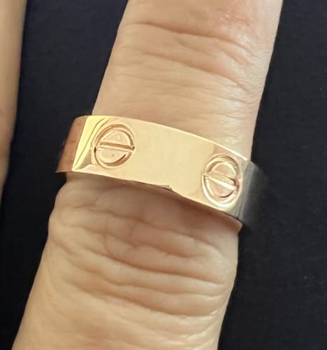 Customer's close-up of the rose gold designer style ring on their finger.