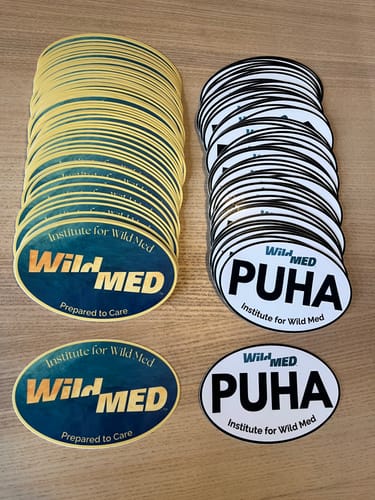 Customer's two sets of oval cut-to-shape stickers. One design is blue and gold, the other is black and white.