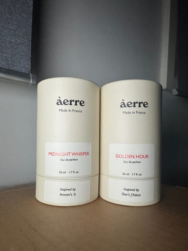 Customer shows their two Àerre fragrances in their cylindrical boxes, including Midnight Whisper.