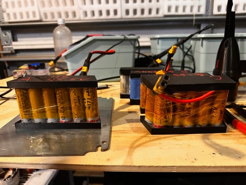 Customer's Molicel 21700 P42A batteries assembled into two custom battery packs on a workbench.