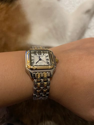 Customer wearing the two-tone silver and gold GREALY DE MAINS watch on their wrist.