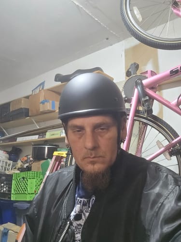 Customer wearing the flat black Polo Switchback Curve helmet, showing its slim, low-profile fit.