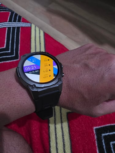 Customer wearing the rugged Gard Pro Ultra 3, showing its sturdy build and a colorful, data-filled watch face on their wrist.