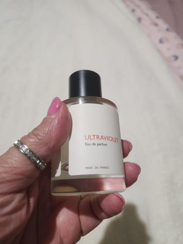 Customer holding their nearly finished bottle of Ultraviolet Eau de parfum.