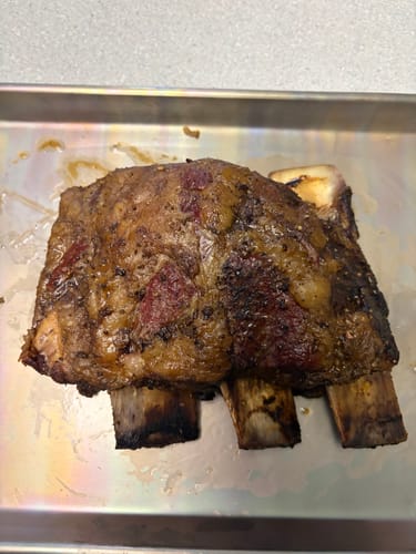 Customer's cooked Bone-In Short Ribs with a seasoned crust on a metal baking sheet.
