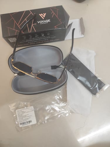 Customer's Co-Pilot Golden Wayfarer Sunglasses in their open case, with the box and cleaning cloth included.