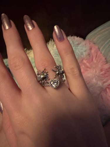 Reviewer's hand wearing the silver-colored CENTIPEDE RING paired with a heart-shaped promise ring.