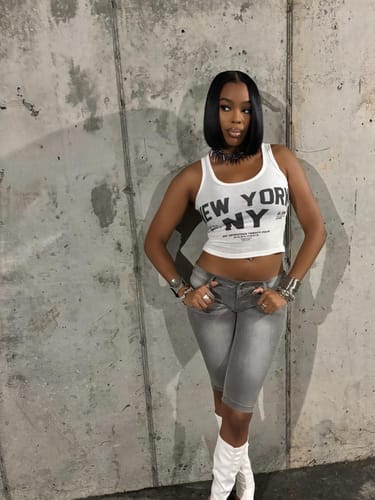 Customer wearing the low-rise grey Denim Capris, styled with a white tank top and boots.