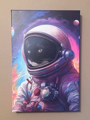 Customer's colorful Galactic Pet canvas showing a black cat's face inside an astronaut helmet in space.