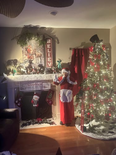 Customer's Vintage Woodland Santa Christmas Wall Art displayed on a mantel above a fireplace in a decorated room.