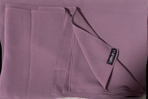 Close-up of the reviewer's lilac gray Classic Chiffon Hijab, folded to show the soft fabric.