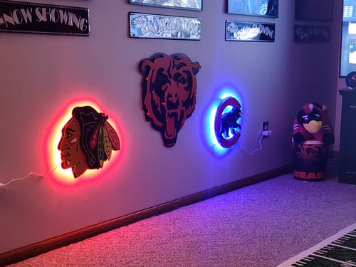 Customer's Chicago Blackhawks 3D vintage wall art with red LED backlighting, mounted in a sports room.