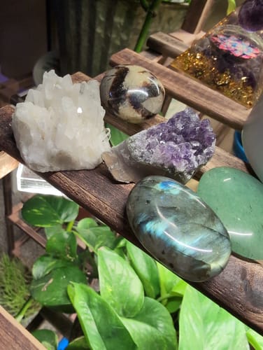Customer's crystal collection from the VIP Crystal Club showing amethyst, quartz, and a polished labradorite stone on a shelf.