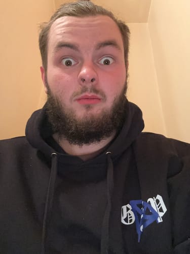 Customer in a close-up photo wearing the heavyweight FEAR KILLS HOODIE.