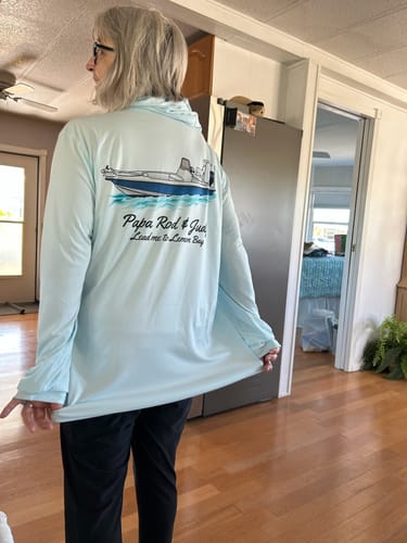 Reviewer models a light blue long-sleeved shirt with a custom boat illustration on the back.
