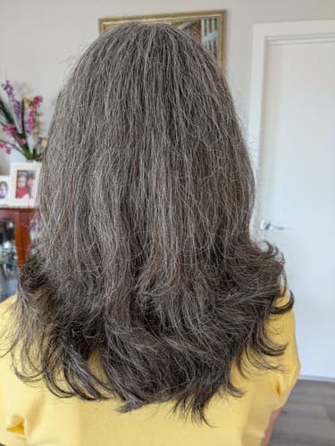 Customer's back view of their grey, fuller-looking hair after using Gloss Hair Growth Shampoo.