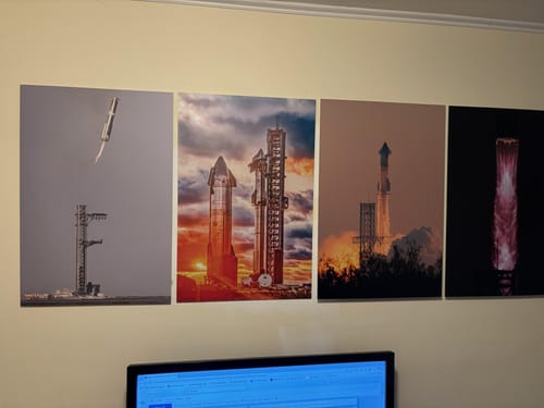 Customer's set of four Wicked Approach aluminum panels showing rocket launches, mounted in a row above a desk.