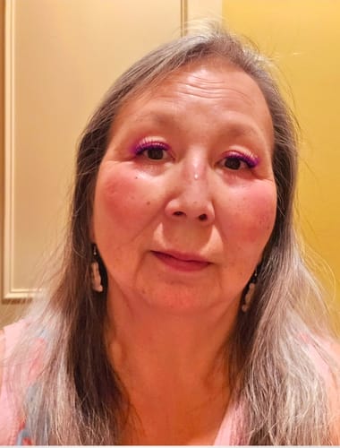 Reviewer showing her face while wearing the purple Editorial Core Colors & Ombre Gossamer® Lashes.