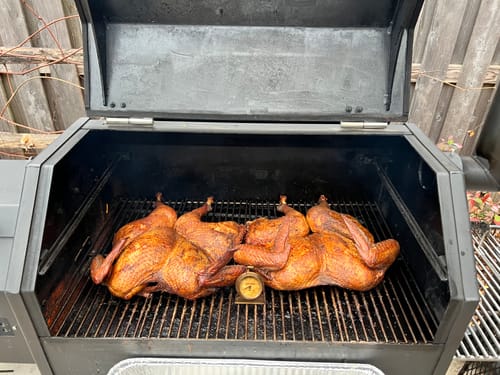 Customer's two turkeys seasoned with Dirty Bird Rub cooking in a large smoker.