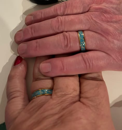 Customer showing two hands wearing matching gold Azara rings with turquoise inlays.