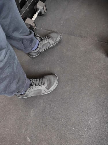 Reviewer wearing the black Notorious Lift Radix shoes on a gym floor, viewed from above.