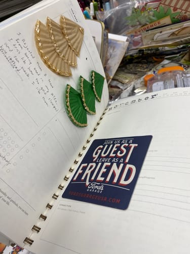 Customer's open Becoming Planner showing a decorated page with handwritten notes and stickers.