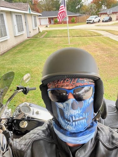 Customer on a motorcycle wearing the low-profile SOA DOT Beanie helmet in Flat Black.