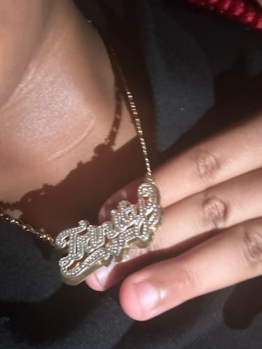 Customer wearing their two-tone personalized double plated name necklace with the name 'Triniyah'.