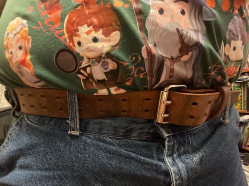 Reviewer wearing the brown leather Woodstock Double Prong Retro Style belt fastened with blue jeans.