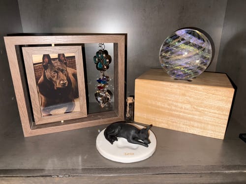 Customer's Illuminated Dichroic Rainbow Orb with Cremains displayed as part of a beautiful pet memorial.