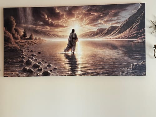 Reviewer's 'Walking on Water - Faith Wall Art II' canvas hanging on a wall, showing a figure walking on water towards the light.