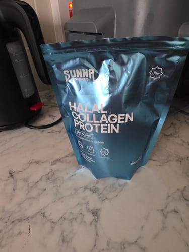 Customer's blue pouch of Halal Collagen Protein sitting on a marble kitchen counter.