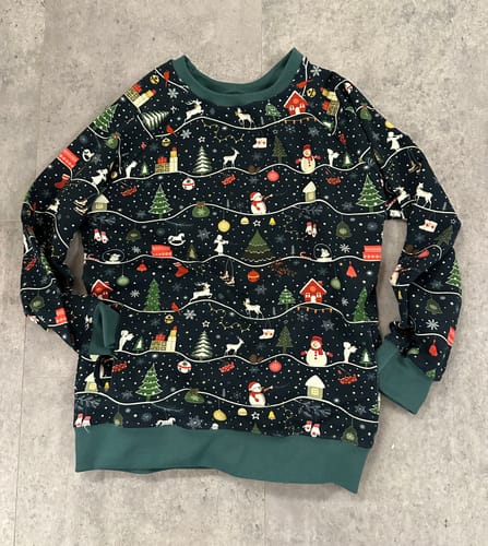 Customer's finished child's sweatshirt made from the festive Snowy Christmas on Midnight French Terry Fabric.