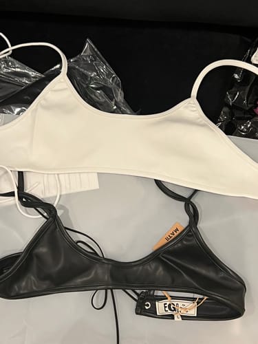 Customer's photo comparing the black EGO BRA to a white one, showing the black bra is visibly smaller.
