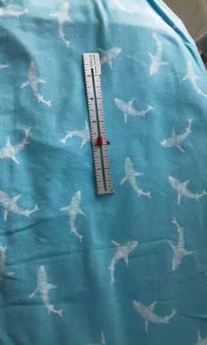 Customer's Shark Splash fabric with a sewing gauge on top showing the print's scale.