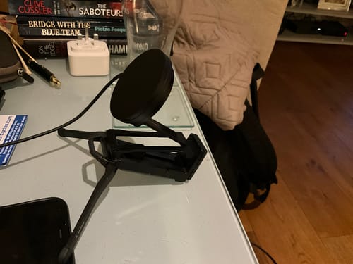 Customer's modified black Spotminders wireless charger mounted on a small tripod on a desk.