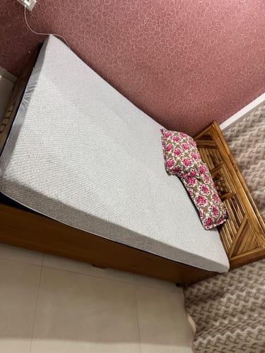 Customer's Flo Anti-Gravity™ Latex Mattress on a bed, showing the grey, textured outer cover.