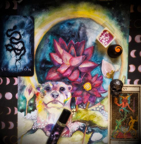 Customer's How Luscious Is The Dark rollerball in an artistic flat lay with tarot cards, chocolates, and a painting.