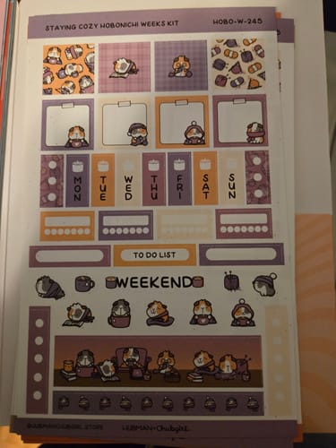 Customer's full sticker sheet for the Staying Cozy Hobonichi Weeks Kit, featuring cute guinea pig designs in purple and orange.