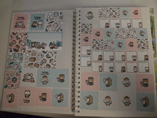 Customer's Holiday Happy Mail Sticker Set organized in a book, showing various decorative box stickers with cute characters.