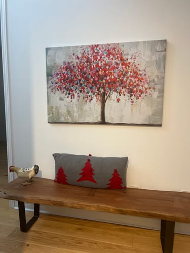 Customer's 'Abstract Colourful Tree' canvas hanging on a wall above a wooden bench in an entryway.