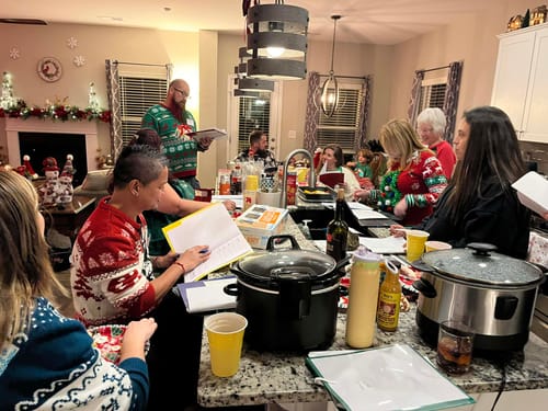 Customers in festive Christmas sweaters playing the Office Christmas Sweater Party Murder Mystery Game at a home party.